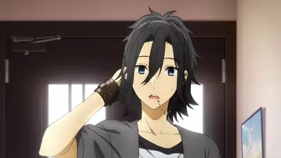 Touching dark hair with lip piercing in front of a door