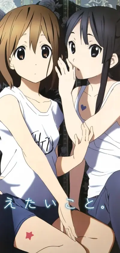 Two animated girls whispering, one with a heart tattoo