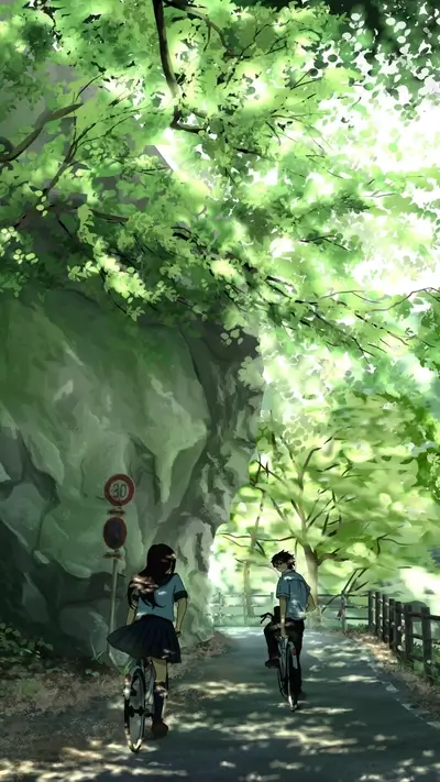Two cyclists riding through tree-lined path with light shining through leaves