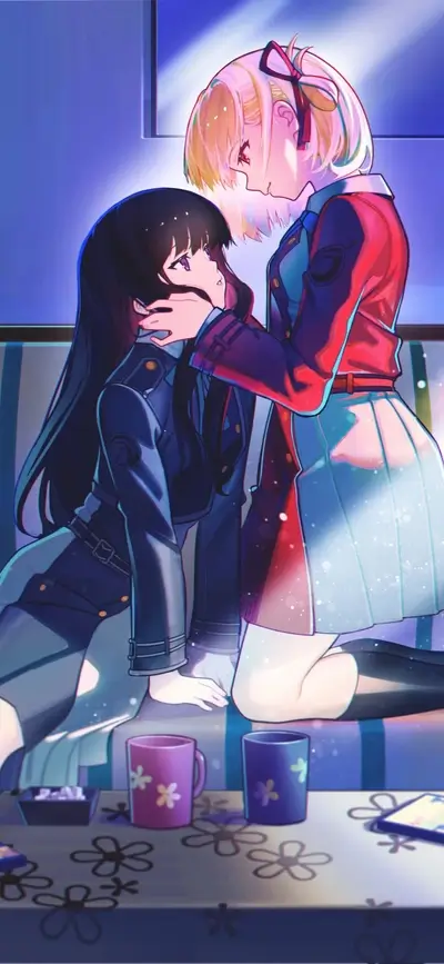 Two girls embracing on a couch