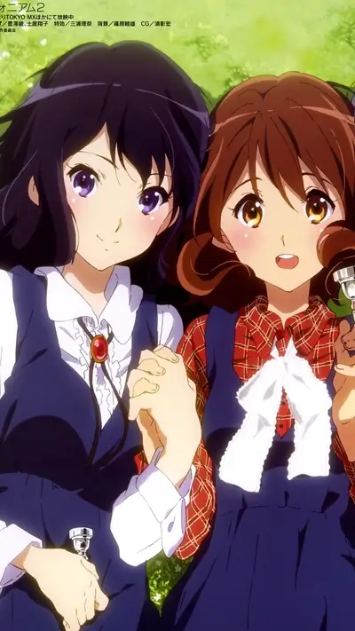 Two girls holding hands in a park