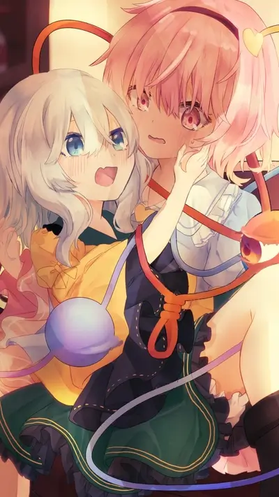 Two girls intertwined, playful expressions, colorful clothing