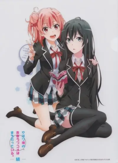 Two girls posing together, one holding a book