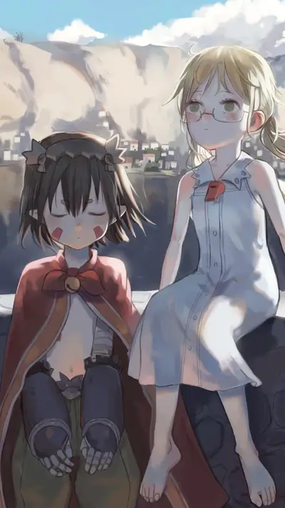 Two girls sitting on a wall overlooking a town