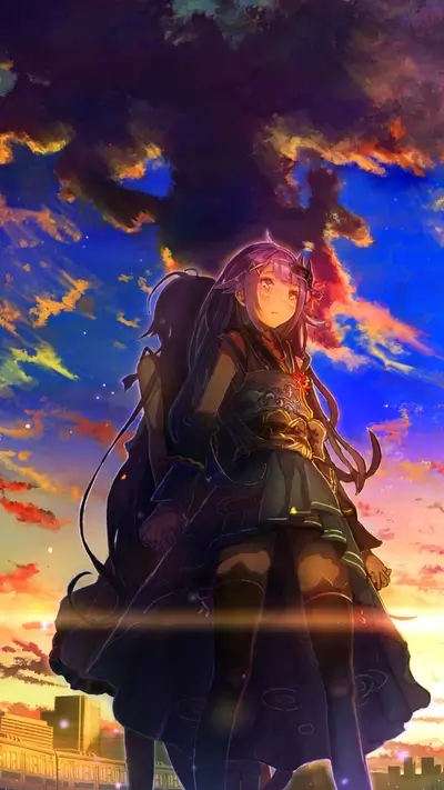 Two girls stand together against a vibrant sunset sky