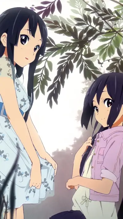 Two girls standing under a tree