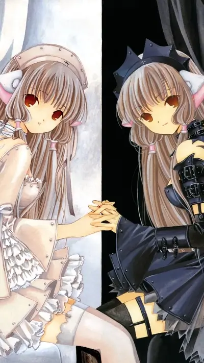 Two identical girls in contrasting outfits holding hands