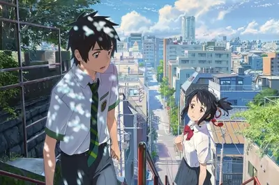 Two school students on a stairway overlooking a city