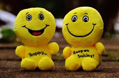 Two smiling yellow plushies sitting close together