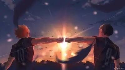 Two volleyball players fist bumping at sunset