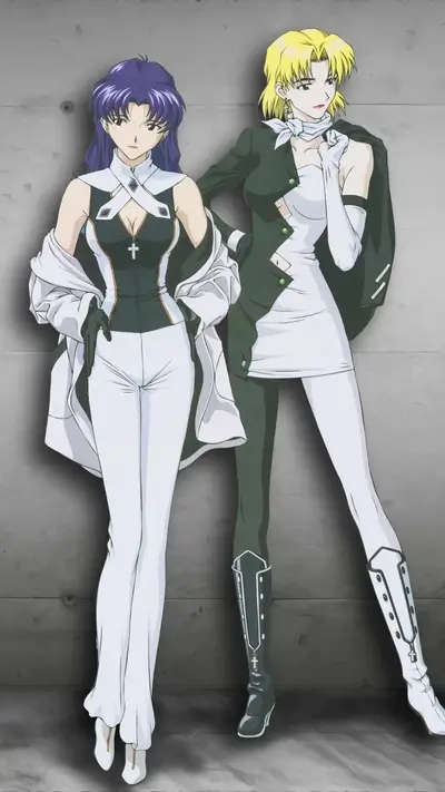 Two women in stylish outfits pose against a gray background