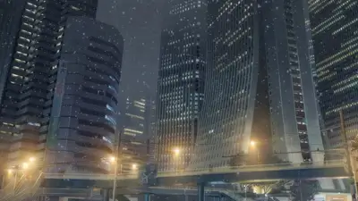 Urban landscape with tall buildings, bridge, snow, and warm streetlights, creating atmospheric scene