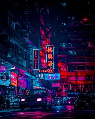 Vibrant neon lights illuminate a bustling Hong Kong street at night