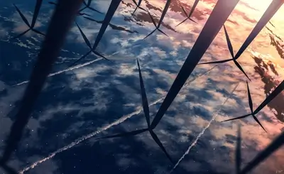 Wind turbines reflected in water, sunset sky