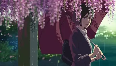 Woman holding umbrella under hanging purple wisteria flowers