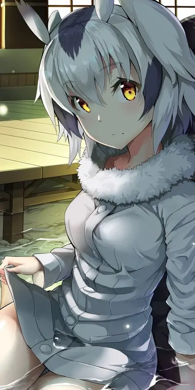Woman with gray hair and yellow eyes sits in a jacket