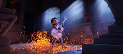 Young boy playing guitar, standing in a room full of flowers