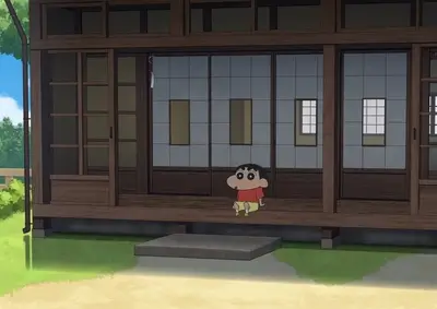 Young boy sitting on the porch of a traditional Japanese house