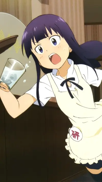 Young girl in apron startled while holding a glass with liquid inside.